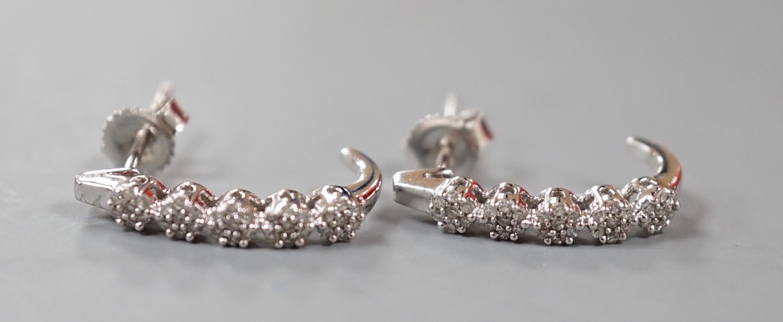 A modern pair of 375 white metal and diamond quintuple cluster set demi-lune earrings, 16mm, gross weight 1.7 grams.